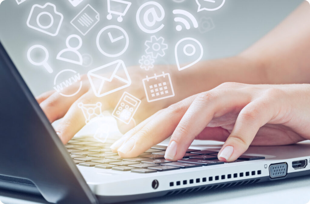 Hands typing on a laptop with several icons floating above it, representing an all-in-one childcare solution